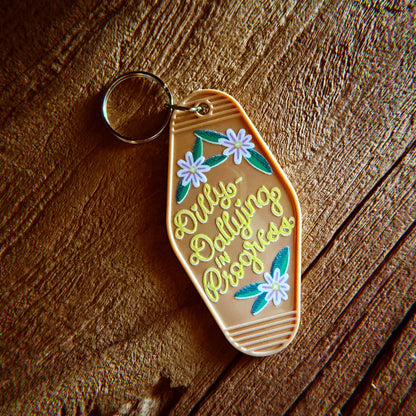 Dilly-Dallying in Progress Keychain, Tan and Silver